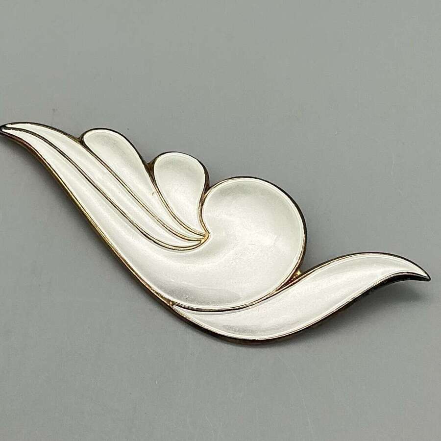 A large and striking David Andersen brooch, beautifully crafted in silver-gilt with white